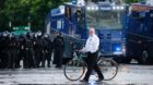 A man walks in front of riot police during the protests at the G20 summit in Hamburg, Germany, July 7, 2017. REUTERS/Hannibal