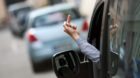 BERLIN, GERMANY  - AUGUST 13: Posed scene, car driver giving another traffic participant his finger on August 13, 2014, in Be