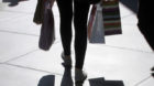 FILE - In this Sept. 29, 2011 file photo, a shopper carrying bags is silhouetted at a mall in Los Angeles. The U.S. economy g