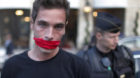 A member of French media watchdog Reporters Without Borders wears a symbolic gag to protest against the visit of Rwanda's Pre