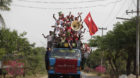 Supporters of Myanmar's pro-democracy leader Aung San Suu Kyi, shout slogans atop a lorry during an election campaign for Apr
