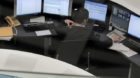 Tokyo Stock Exchange employees work at the computer terminal in Tokyo, Japan, Wednesday, April 11, 2012. Asian shares slumped