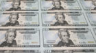 The new Series 2006 $20 currency notes, bearing the signatures of Treasury Secretary Henry Paulson and Anna Escobedo, treasur
