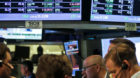 FILE- In a July 13, 2012, file photo, traders work as the New York Stock Exchange nears closing. JPMorgan Chase blew away a c