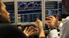 Brokers work in a trading room of a Portuguese bank in Lisbon, Wednesday, Jan. 16, 2013. Portugal has raised euro 2.5 billion