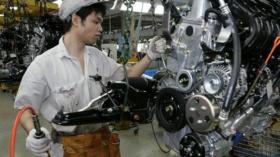 Workers build automobile engines on a production line at the Guangzhou Honda Auto Co., Ltd. in Guangzhou, China, Friday 18 Ma