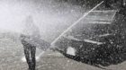 A student demonstrator is sprayed with water during a protest against the government of President Juan Manuel Santos in Bogot