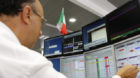 A trader checks monitors at a bank, in Milan, Italy, Monday, Aug. 8, 2011. A risky European Central Bank decision to fight th