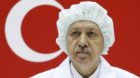 Turkey's Prime Minister Tayyip Erdogan, wearing a dust-free garment, attends a ceremony to mark the shipment of the Turksat-4