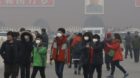 epa04100725 Visitors wear protective masks as they go around the Tiananmen Square amidst smog in Beijing, China, 26 February 