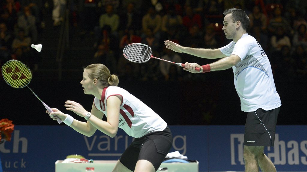 Denmark's Joachim Fischer Nielsen, right, and Christinna Pedersen, left, serve a shuttlecock to China's Nan Zhang and Jinhua Tang during their mixed doubles final match at the Badminton Swiss Open tournament in the St. Jakobshalle in Basel, Switzerland, o
