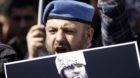 A pro-Islamist protester shouts slogans against the Russian government as he holds a picture of North Caucasus rebel leader D