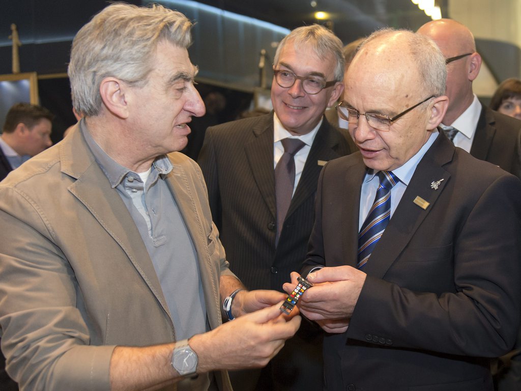 epa04142981 Swiss Federal Councillor Ueli Maurer (R) is given a Swatch wristwatch from member of the Board of Directors of the Swatch Group Nick Hayek (L) during the official opening of the Baselworld international watch and jewellery fair in Basel, Switz