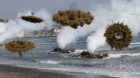 Amphibious assault vehicles of the South Korean Marine Corps throw smoke bombs as they move to land on shore during a U.S.-So