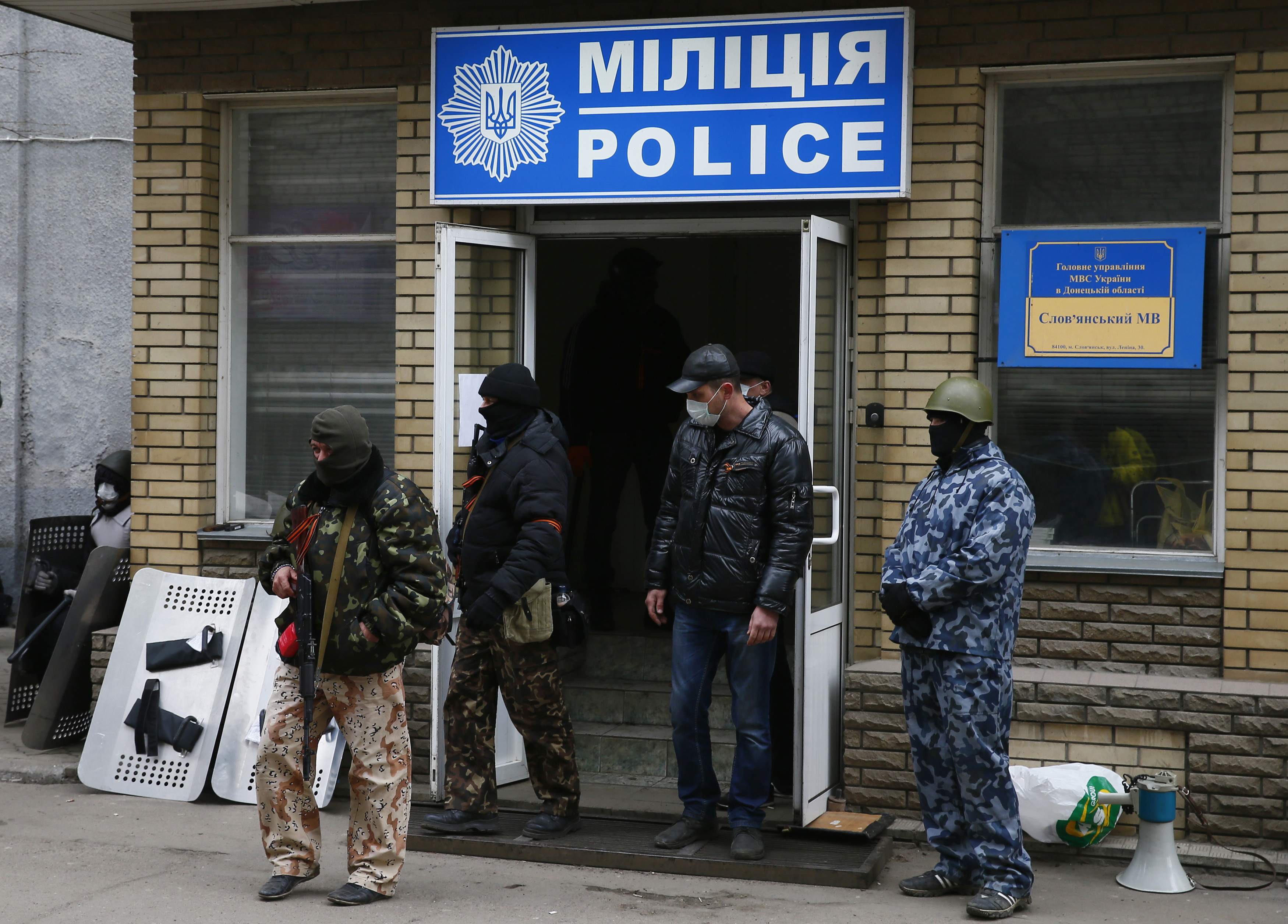 Armed men stand in front of the police headquarters building in Slaviansk, April 12, 2014. At least 15 armed men seized the police headquarters in the eastern Ukrainian city of Slaviansk on Saturday, extending takeovers of public building by pro-Russian m