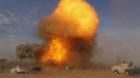 An explosion is seen during a car bomb attack at a Shi'ite political organisation's rally in Baghdad, April 25, 2014. A serie