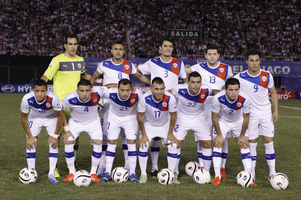 FILE - In this June 7, 2013 file photo, Chile team poses prior to the start the 2014 World Cup qualifying soccer match between Paraguay and Chile in Asuncion, Paraguay. Background from left: goalkeeper Claudio Bravo, Arturo Vidal, Marcos Gonzalez, Jose Ro