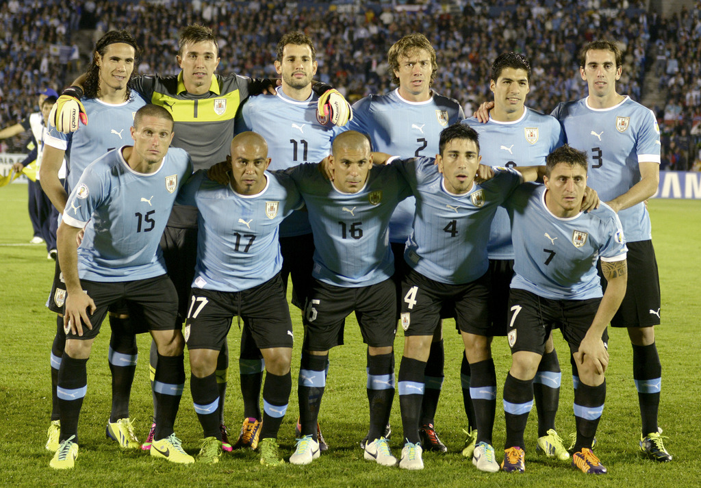 FILE - In this Oct. 15, 2013 file photo, Uruguay soccer team poses prior to the start the 2014 World Cup qualifying soccer match between Uruguay and Argentina in Montevideo, Uruguay. Foreground from left: Diego Perez, Egidio Arevalo, Maximiliano Pereira, 