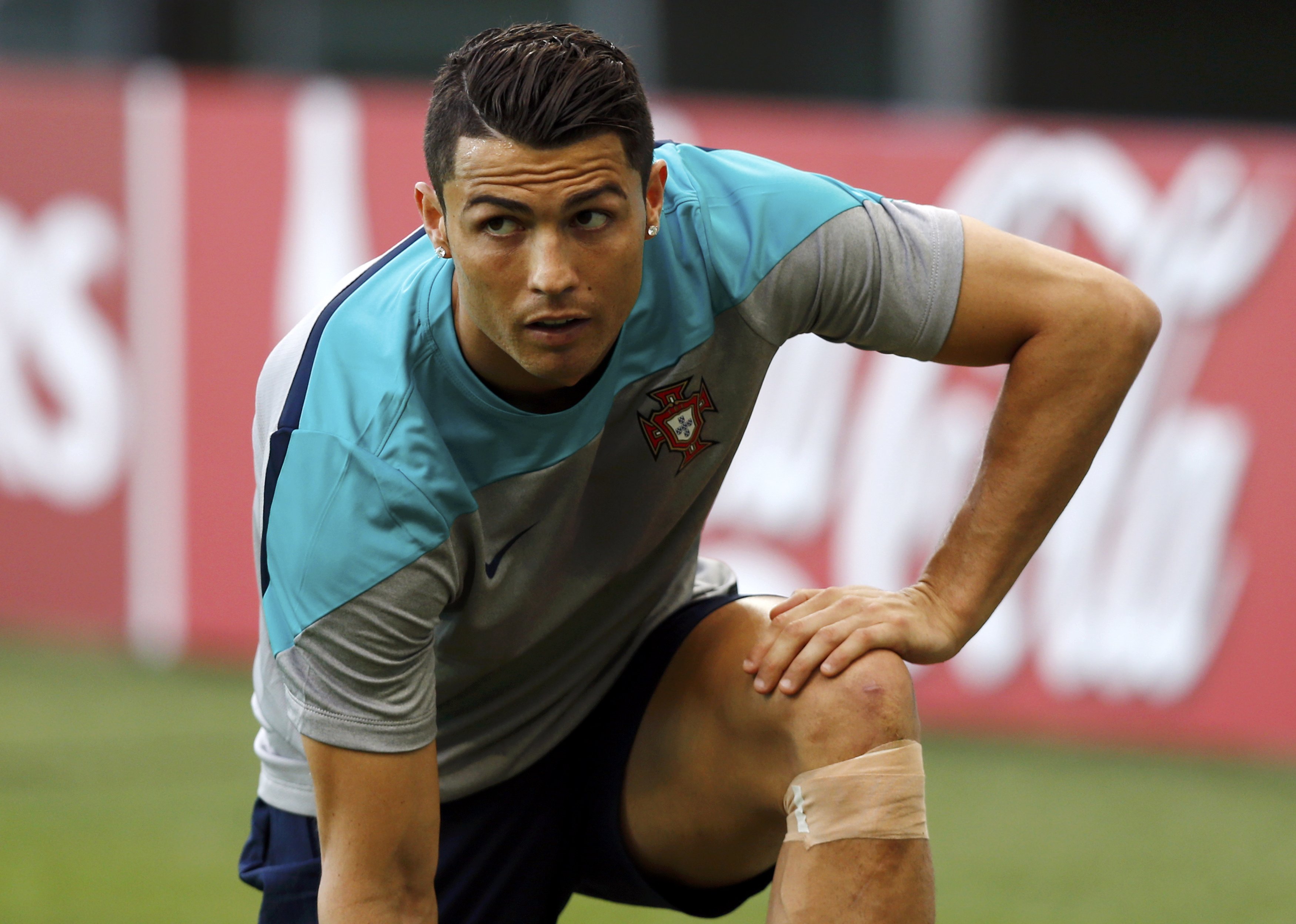 Portugal's Cristiano Ronaldo wears a bandage below his left knee during a training session at the Arena Fonte Nova stadium ahead of their 2014 World Cup against Germany in Salvador, June 15, 2014.    REUTERS/Marcos Brindicci (BRAZIL  - Tags: SPORT SOCCER 