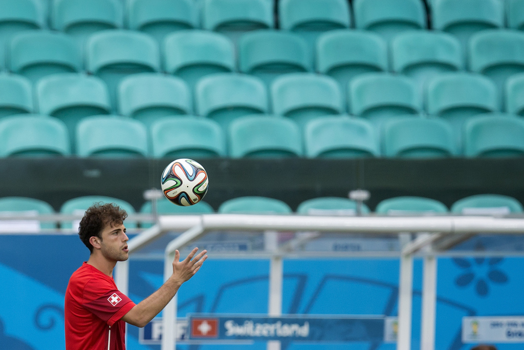 Switzerland's Admir Mehmedi throws a ball during a training session of the Swiss national soccer team in the Arena Fonte Nova in Salvador, Brazil, Thursday, June 19, 2014, one day prior to the group E premiminary round match against France. (KEYSTONE/Pete