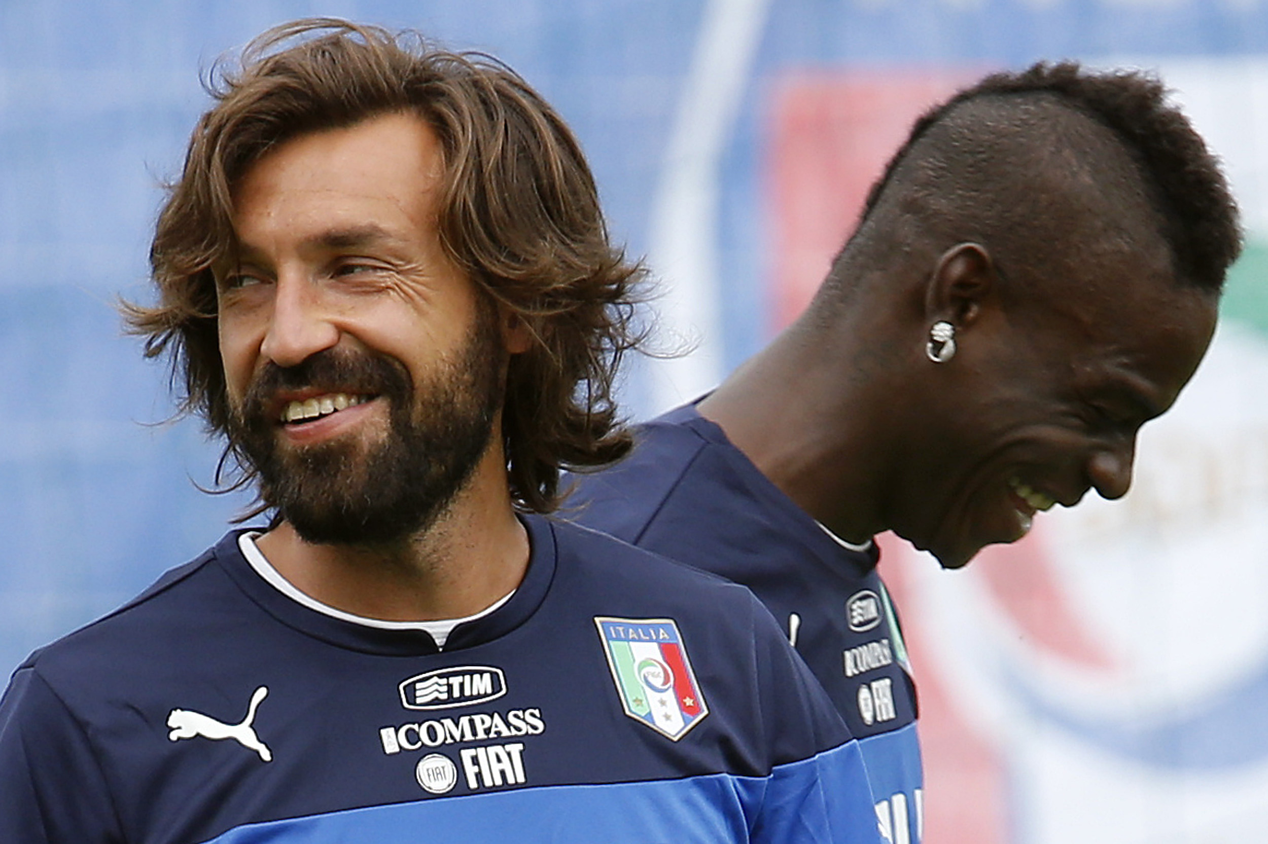 Italy's national soccer players Andrea Pirlo and Mario Balotelli (R) smile during a training session ahead of the 2014 World Cup at the Portobello training center in Mangaratiba June 11, 2014.  REUTERS/Alessandro Garofalo (BRAZIL  - Tags: SPORT SOCCER WOR