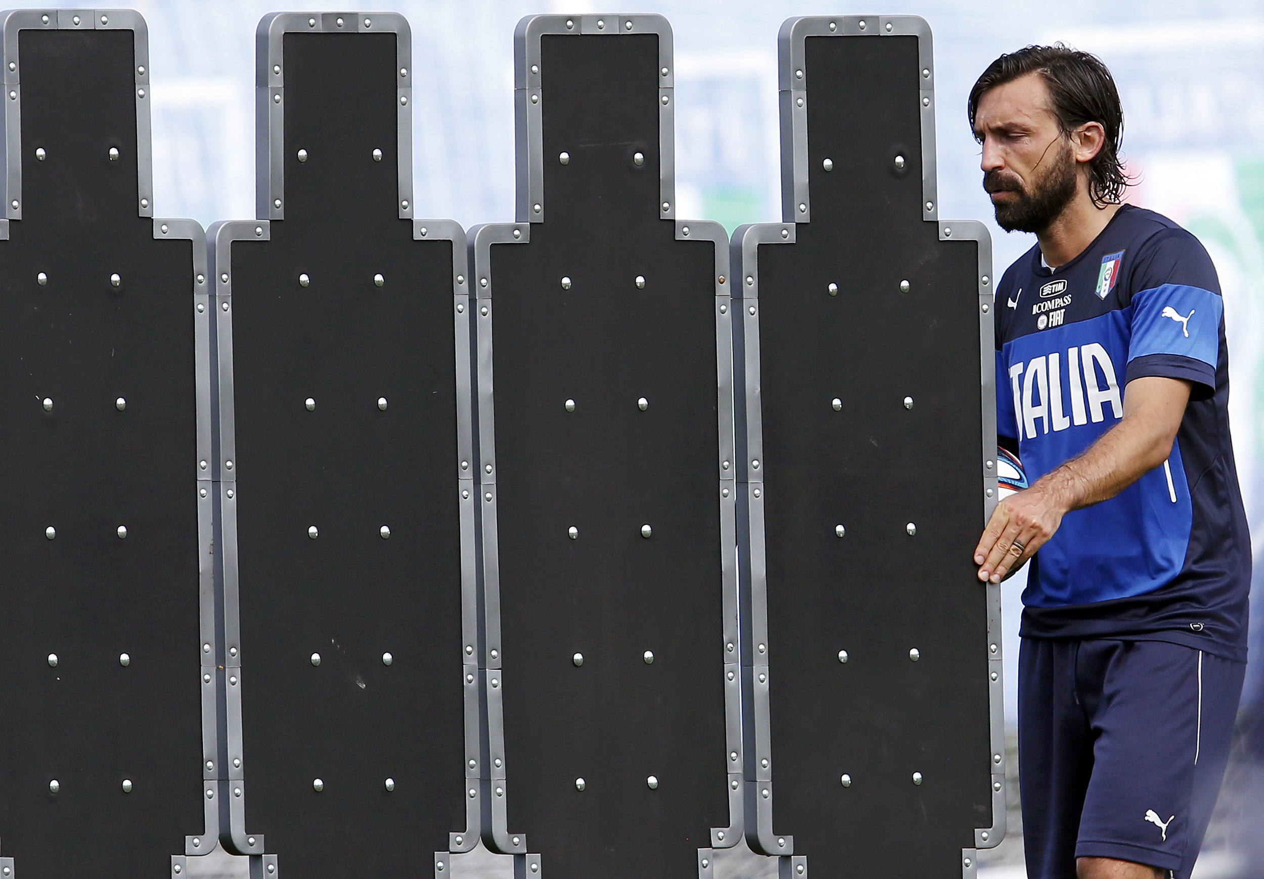 Italy's national soccer player Andrea Pirlo moves the barrier for the free kicks during a training session ahead of the 2014 World Cup at the Portobello training center in Mangaratiba June 11, 2014.  REUTERS/Alessandro Garofalo (BRAZIL  - Tags: SPORT SOCC