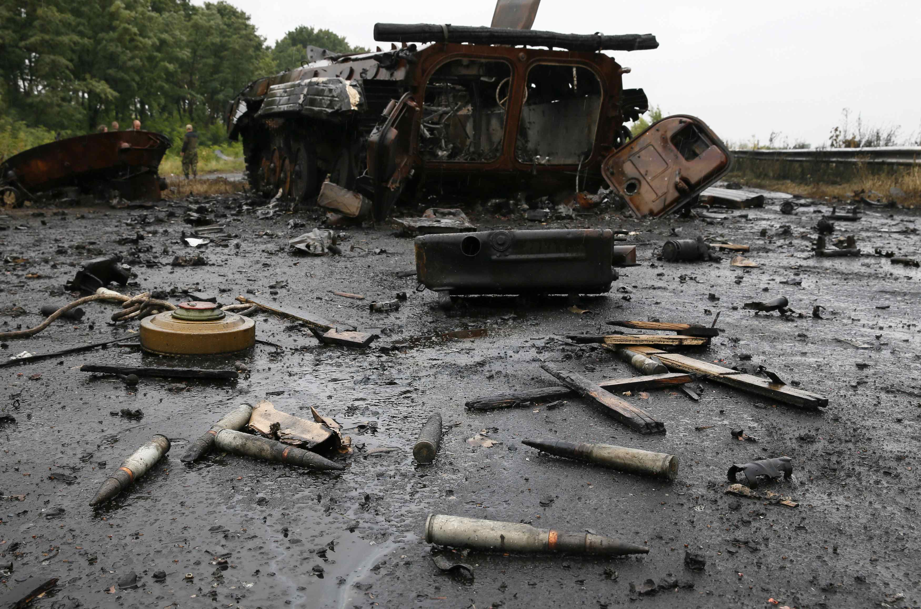 Ammunition and mines lie near a destroyed vehicle just outside the eastern Ukrainian town of Slaviansk July 7, 2014. Ukraine's richest man pleaded with the government on Monday not to bomb Donetsk, a city of a million people where hundreds of heavily arme