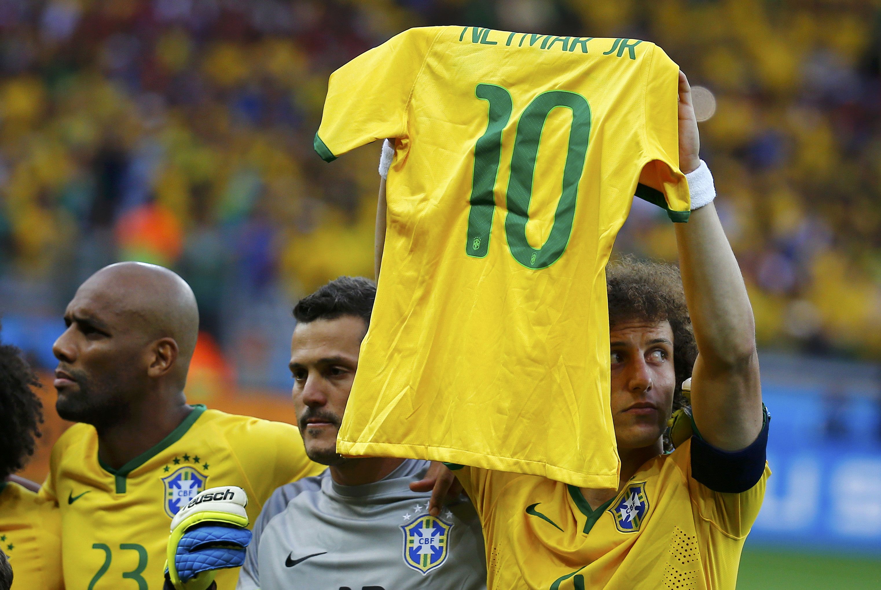 Brazil's David Luiz holds up the jersey of his teammate Neymar during the singing of national anthems before their 2014 World Cup semi-finals against Germany at the Mineirao stadium in Belo Horizonte July 8, 2014. REUTERS/Kai Pfaffenbach (BRAZIL  - Tags: 