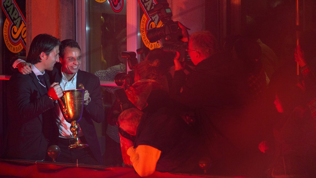 FC Basel's head coach Murat Yakin, left, and president Bernhard Heusler, right, pose for the photographers while players and staff of Switzerland's soccer club FC Basel celebrate their soccer championship title with their fans on the balcony of the Casino