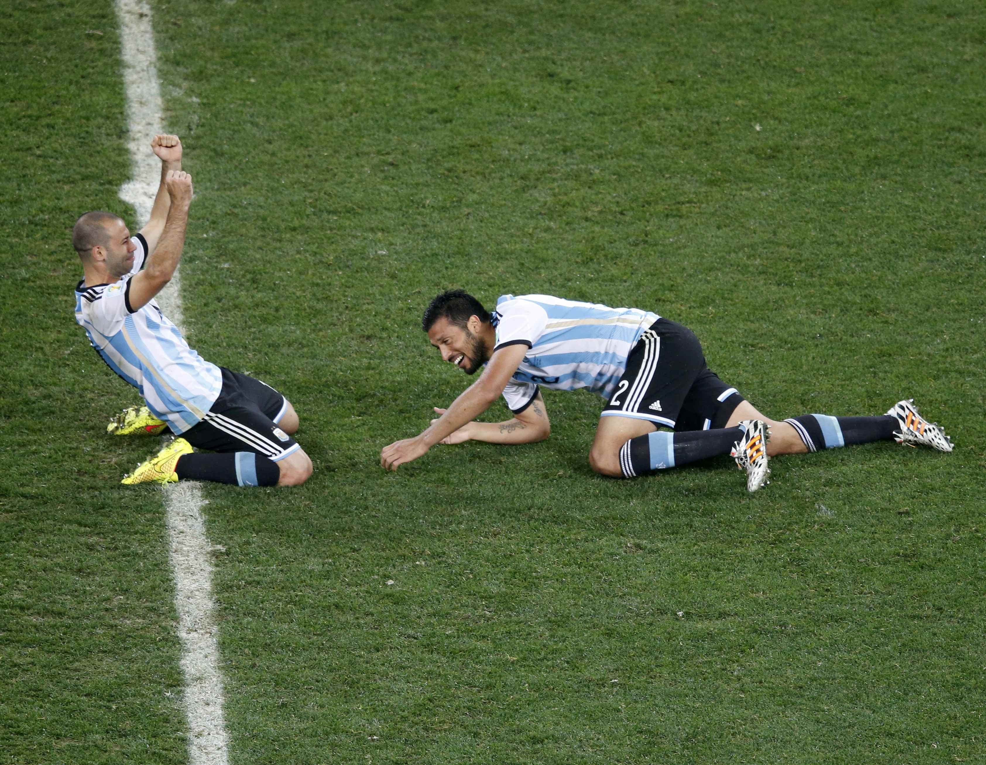 Argentina's Javier Mascherano (L) and Ezequiel Garay celebrate winning their 2014 World Cup semi-finals against the Netherlands at the Corinthians arena in Sao Paulo July 9, 2014.  REUTERS/Paulo Whitaker (BRAZIL  - Tags: SOCCER SPORT WORLD CUP TPX IMAGES 