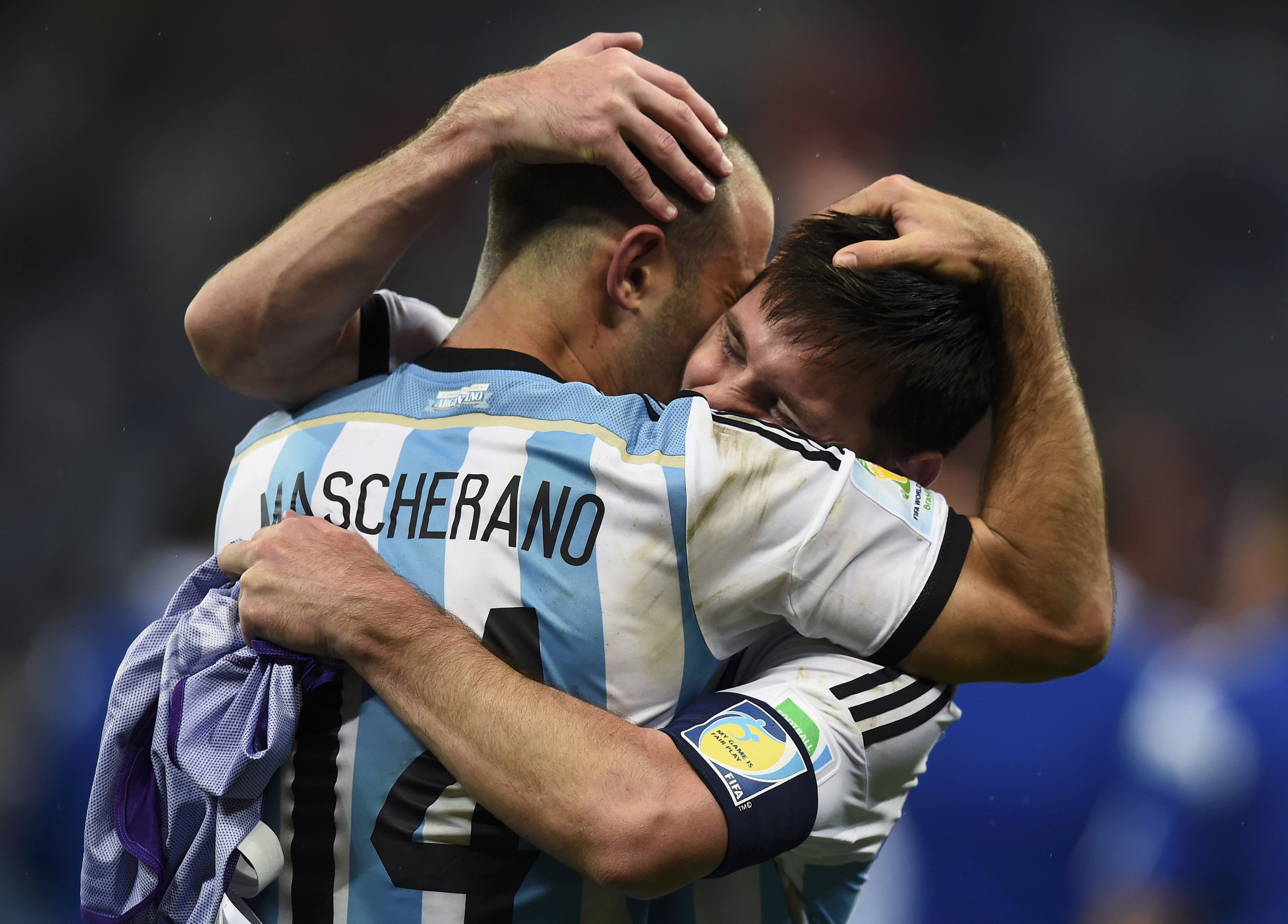 Argentina's Javier Mascherano hugs teammate Lionel Messi (back) after their team's victory over the Netherlands at the end of their 2014 World Cup semi-finals at the Corinthians arena in Sao Paulo July 9, 2014. REUTERS/Dylan Martinez (BRAZIL  - Tags: SOCC