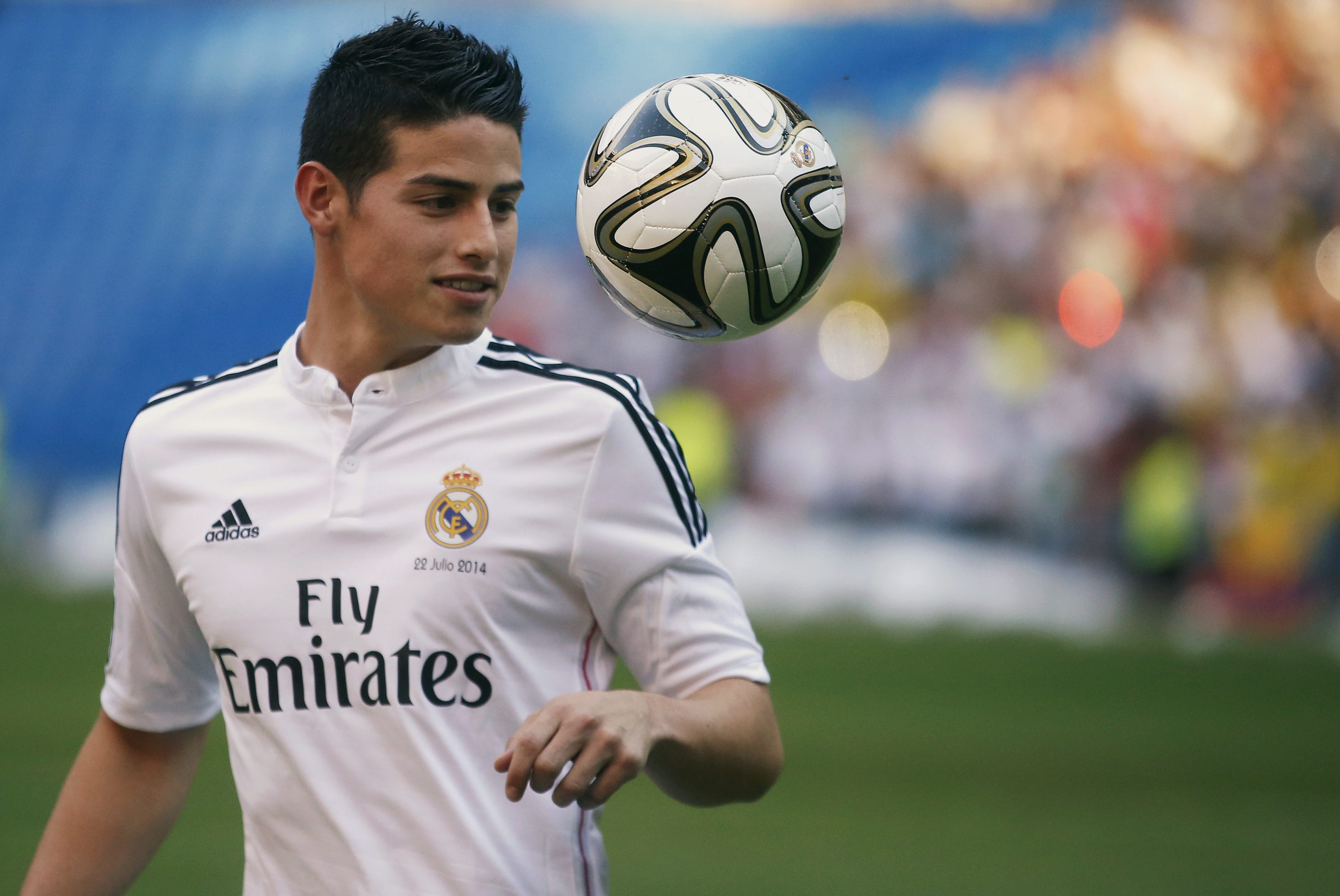 Colombia's soccer player James Rodriguez controls the ball during his presentation at the Santiago Bernabeu stadium in Madrid, July 22, 2014. Real Madrid have signed Rodriguez from Monaco on a six-year contract, the La Liga club said on Tuesday. The World