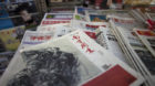 A New Year edition of Southern Weekly, center, published on Thursday Jan. 3, 2013, is exhibited at a newsstand in Beijing, Ch