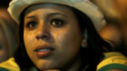 A Brazil soccer fan cries as she watches her team lose to Germany in a semifinal World Cup game on TV in Belo Horizonte, Braz