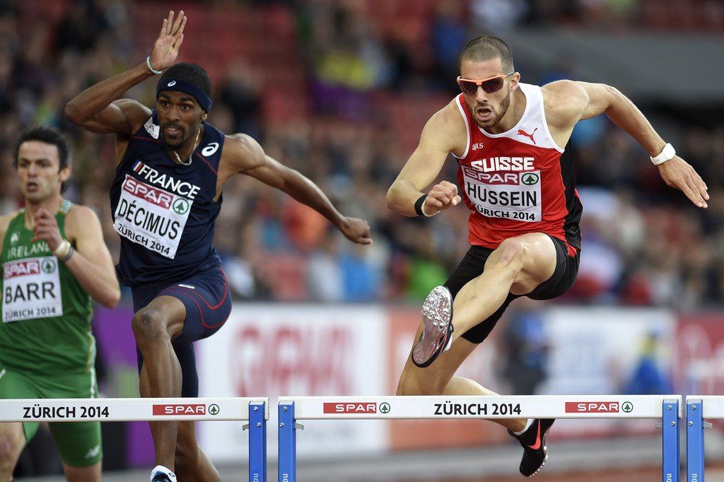 Kariem Hussein from Switzerland, right, competes next to Yoan Decimus from France, left, in the men's 400m hurdles semifinal, at the second day of the European Athletics Championships in the Letzigrund Stadium in Zurich, Switzerland, Wednesday, August 13,
