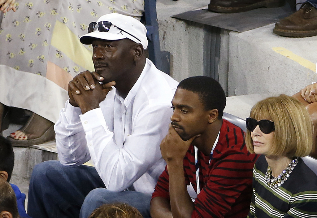 Former NBA basketball player Michael Jordan, left, and fashion editor Anna Wintour, right, attend a match between Roger Federer, of Switzerland, and Marinko Matosevic, of Australia, during the opening round of the U.S. Open tennis tournament Tuesday, Aug.