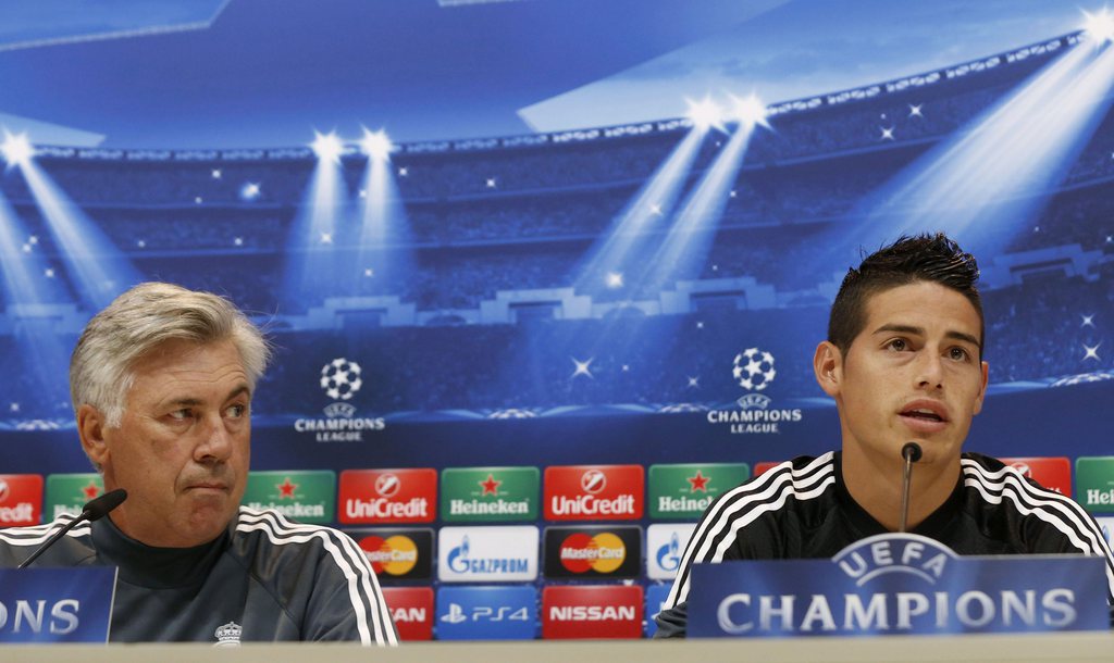 epa04401607 Head coach of Real Madrid, Italian Carlo Ancelotti (L) and his player James Rodriguez hold a press conference following a training session at the Valdebebas sports city in the outskirts of Madrid, Spain, 15 September 2014. Real Madrid will fac