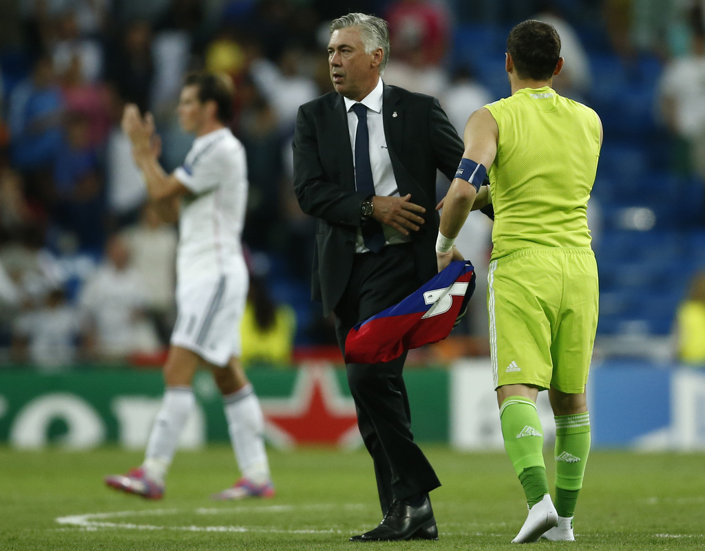 Real's Carlo Ancelotti walks past Real's Iker Casillas at the end of the Champions League Group B soccer match between Real Madrid and Basel at the Santiago Bernabeu stadium in Madrid, Spain, Tuesday, Sept. 16, 2014. (AP Photo/Andres Kudacki)