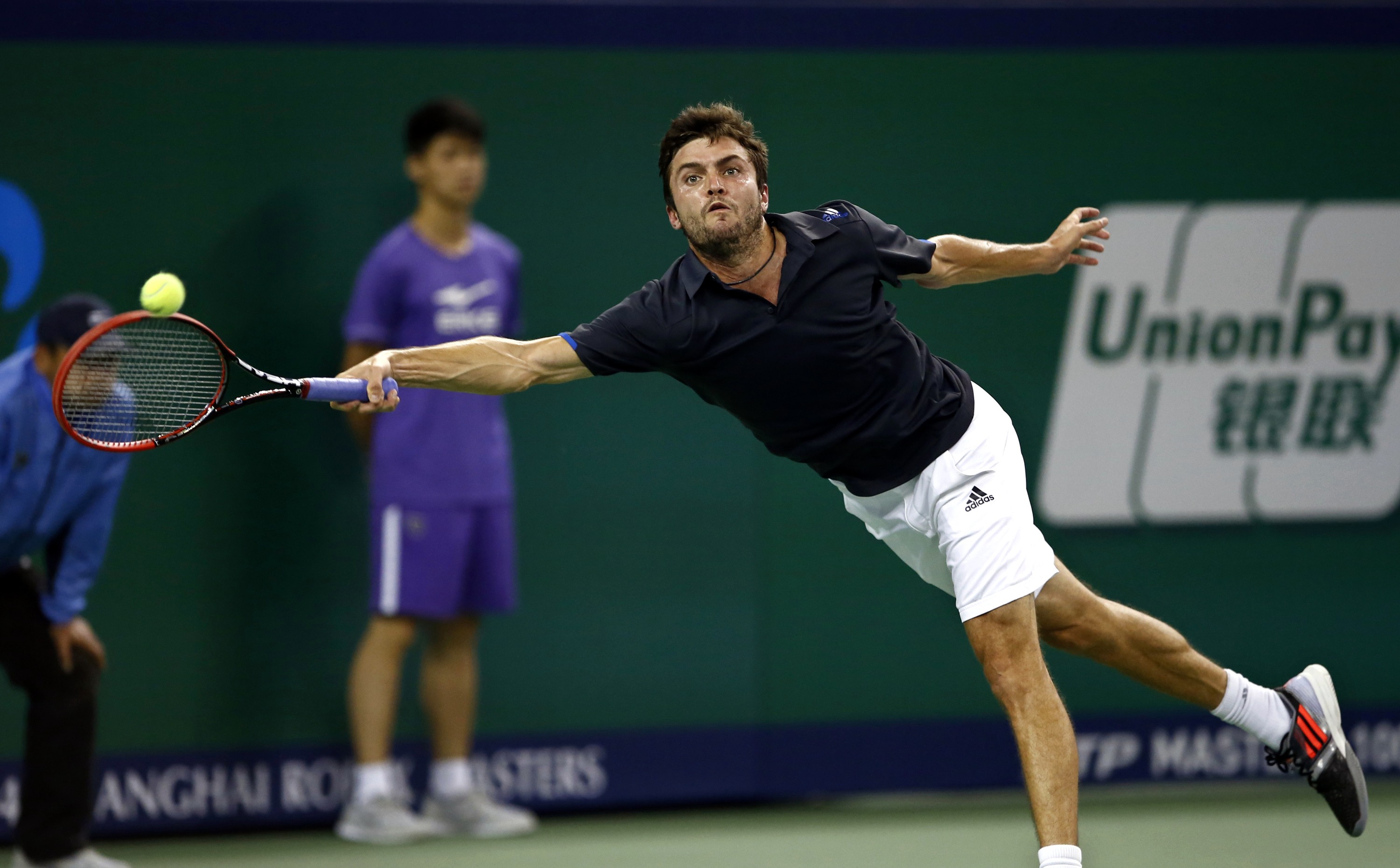 Gilles Simon of France returns a shot to Roger Federer of Switzerland during the men's singles final match at the Shanghai Masters tennis tournament in Shanghai October 12, 2014. REUTERS/Aly Song (CHINA - Tags: SPORT TENNIS)