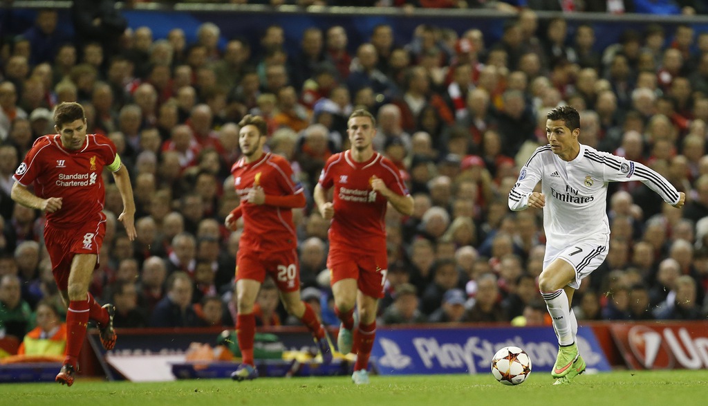 Real Madrid's Cristiano Ronaldo, right, races away from Liverpool's Steven Gerrard, left, during the Champions League group B soccer match between Liverpool and Real Madrid at Anfield Stadium, Liverpool, England, Wednesday Oct. 22, 2014. (AP Photo/Jon Super)
