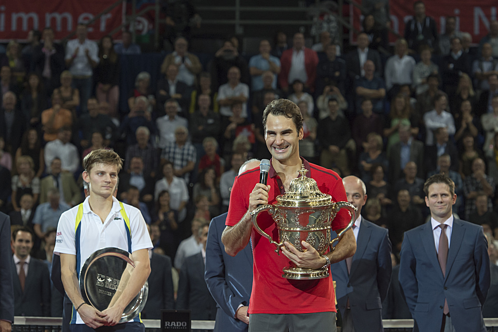 Switzerland's Roger Federer, right, speaks to the audience after winning the final match against Belgium's David Goffin, left, at the Swiss Indoors tennis tournament at the St. Jakobshalle in Basel, Switzerland, on Sunday, October 26, 2014. (KEYSTONE/Georgios Kefalas)
