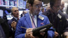 Richard Scardino, center, works with fellow traders on the floor of the New York Stock Exchange, Wednesday, Oct. 29, 2014. Ma