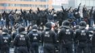 German riot police officers face protesters during a demonstration by neo-Nazis and self-styled soccer hooligans against ultr