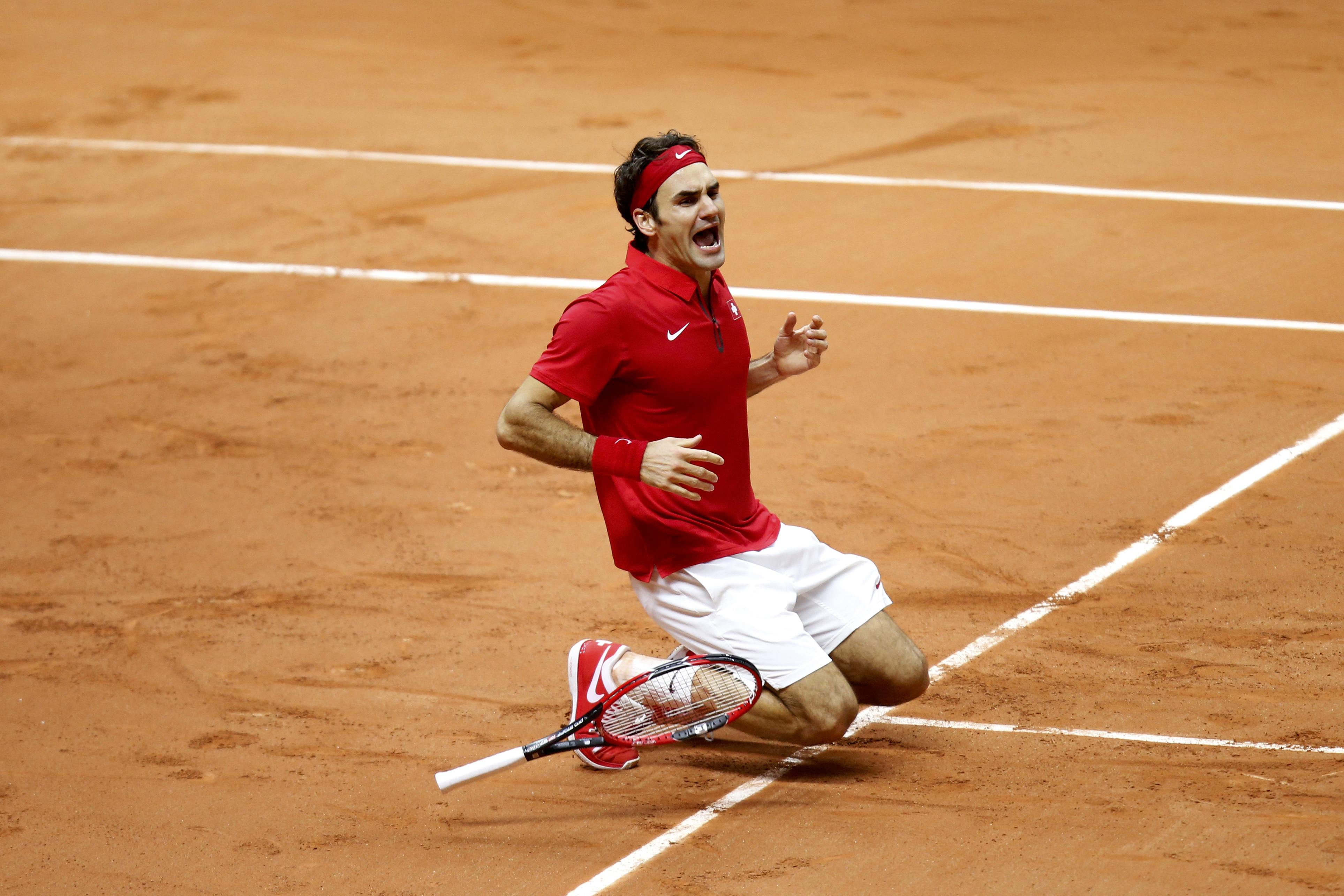 Switzerland's Roger Federer reacts after he defeated France's Richard Gasquet during their Davis Cup final singles tennis match at the Pierre-Mauroy stadium in Villeneuve d'Ascq, near Lille, November 23, 2014. Roger Federer beat Richard Gasquet on Sunday to give Switzerland their first Davis Cup title with a 3-1 victory over hosts France in the final. REUTERS/Charles Platiau (FRANCE - Tags: SPORT TENNIS TPX IMAGES OF THE DAY)