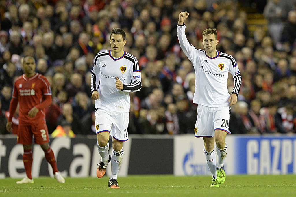 Basel's Fabian Schaer, left, and Fabian Frei, right, cheer after scoring during an UEFA Champions League group B matchday 6 soccer match between Britain's Liverpool FC and Switzerland's FC Basel 1893 at the Anfield stadium in Liverpool, Great Britain, on Tuesday, December 9, 2014. (KEYSTONE/Georgios Kefalas)