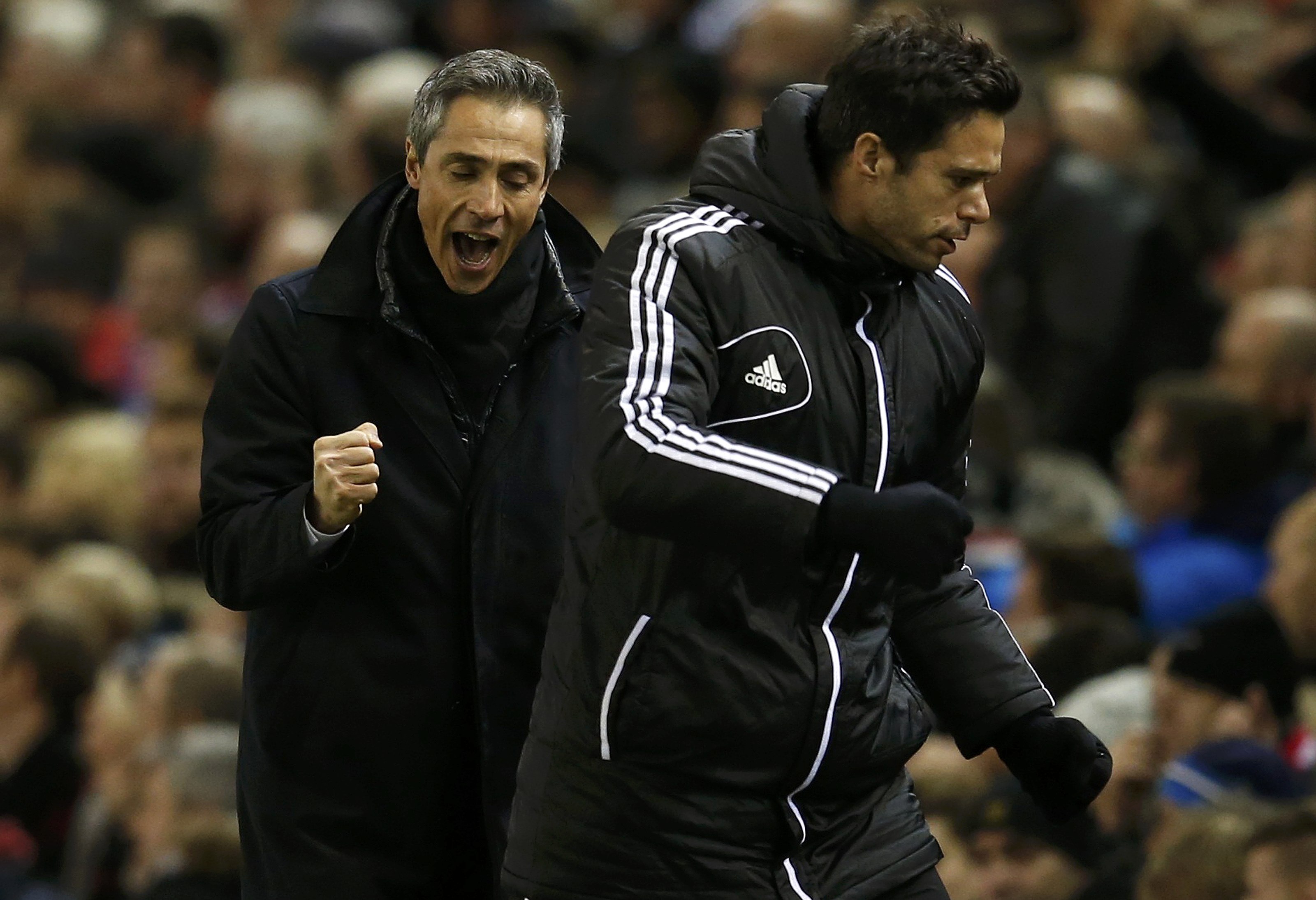FC Basel's coach Paulo Sousa (L) celebrates his team's first goal during their Champions League Group B soccer match against Liverpool at Anfield in Liverpool, northern England, December 9, 2014. REUTERS/Phil Noble (BRITAIN - Tags: SOCCER SPORT)