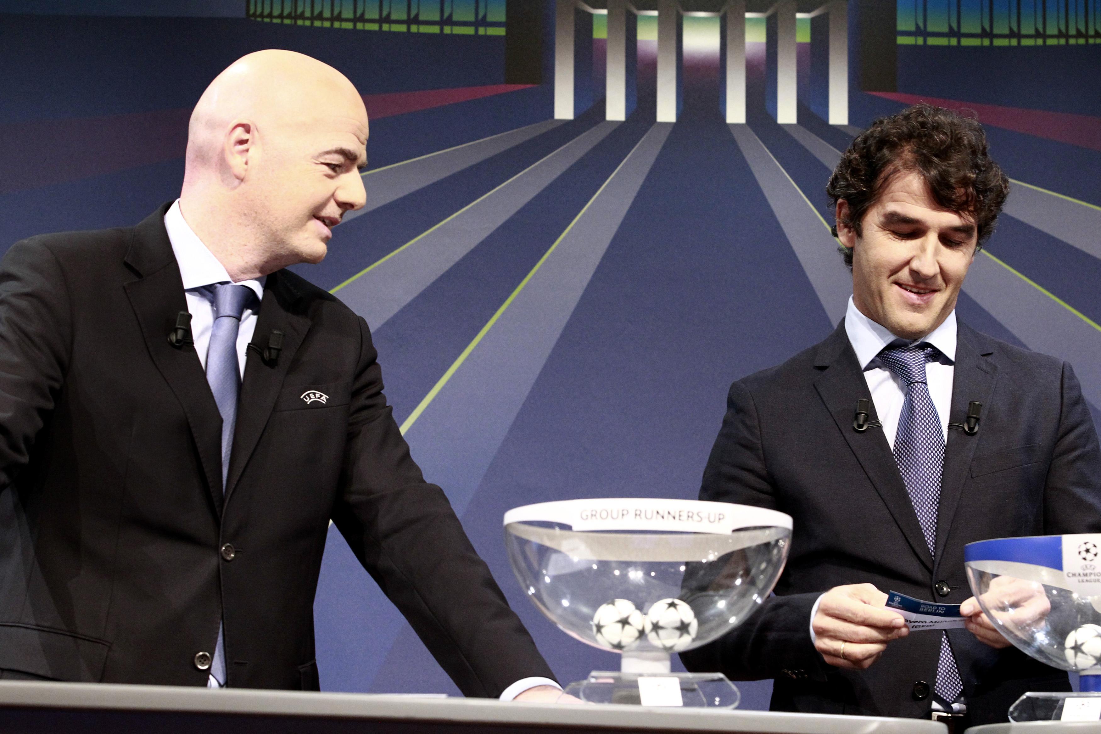 UEFA General Secretary Gianni Infantino (L) stands next to Karl-Heinz Riedle, ambassador for the UEFA Champions League final in Berlin, as they conduct the draw for Champions League round of 16 soccer matches at the UEFA headquarters in Nyon December 15, 2014. REUTERS/Pierre Albouy (SWITZERLAND - Tags: SPORT SOCCER)