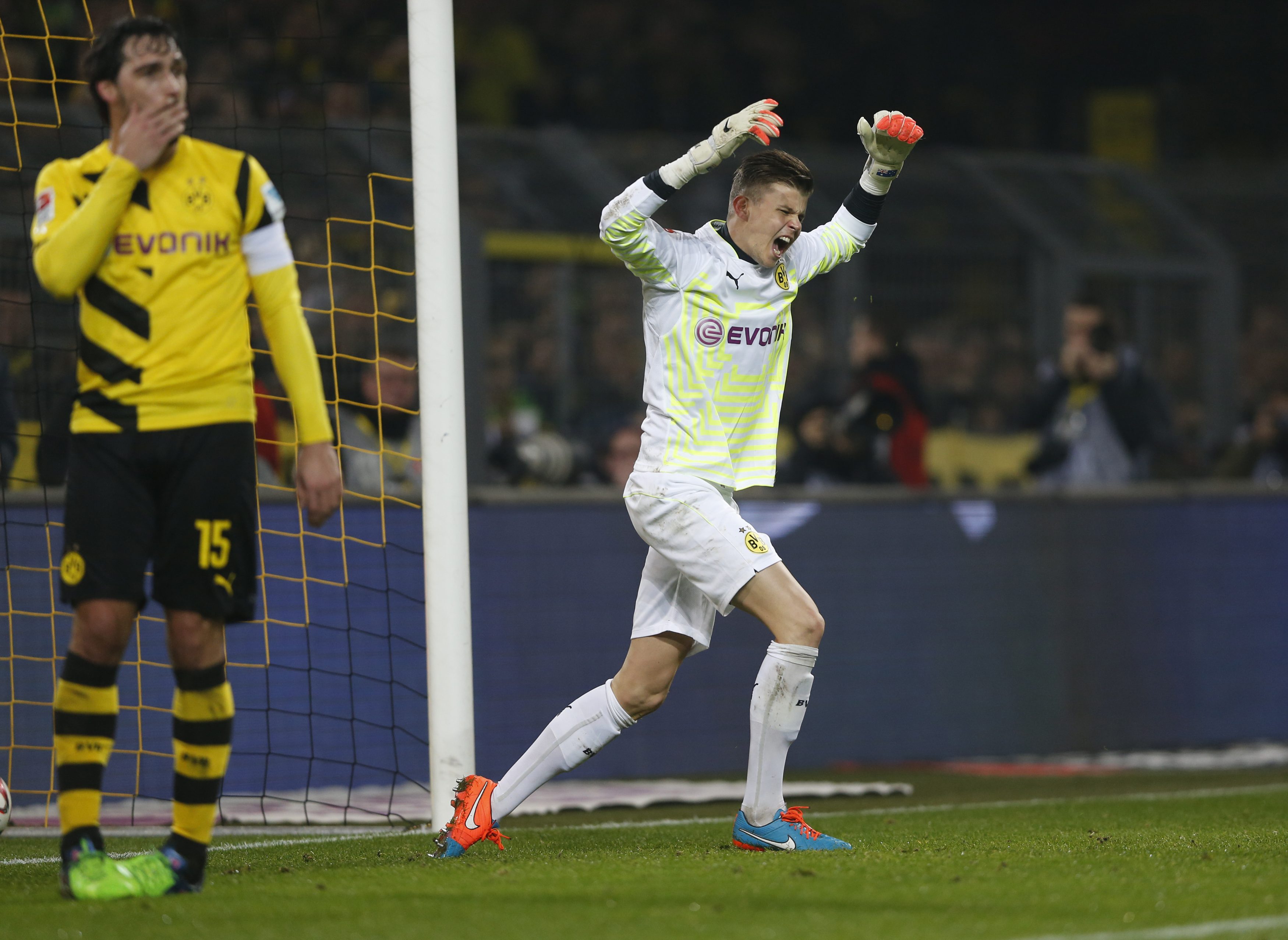 Borussia Dortmund's goalkeeper Mitch Langerak reacts after failing to stop a free kick that resulted in a goal during his team's German first division Bundesliga soccer match against VFL Wolfsburg in Dortmund December 17, 2014. At left is Dortmund's Mats Hummels. REUTERS/Wolfgang Rattay (GERMANY - Tags: SPORT SOCCER) DFL RULES TO LIMIT THE ONLINE USAGE DURING MATCH TIME TO 15 PICTURES PER GAME. IMAGE SEQUENCES TO SIMULATE VIDEO IS NOT ALLOWED AT ANY TIME. FOR FURTHER QUERIES PLEASE CONTACT DFL DIRECTLY AT + 49 69 650050