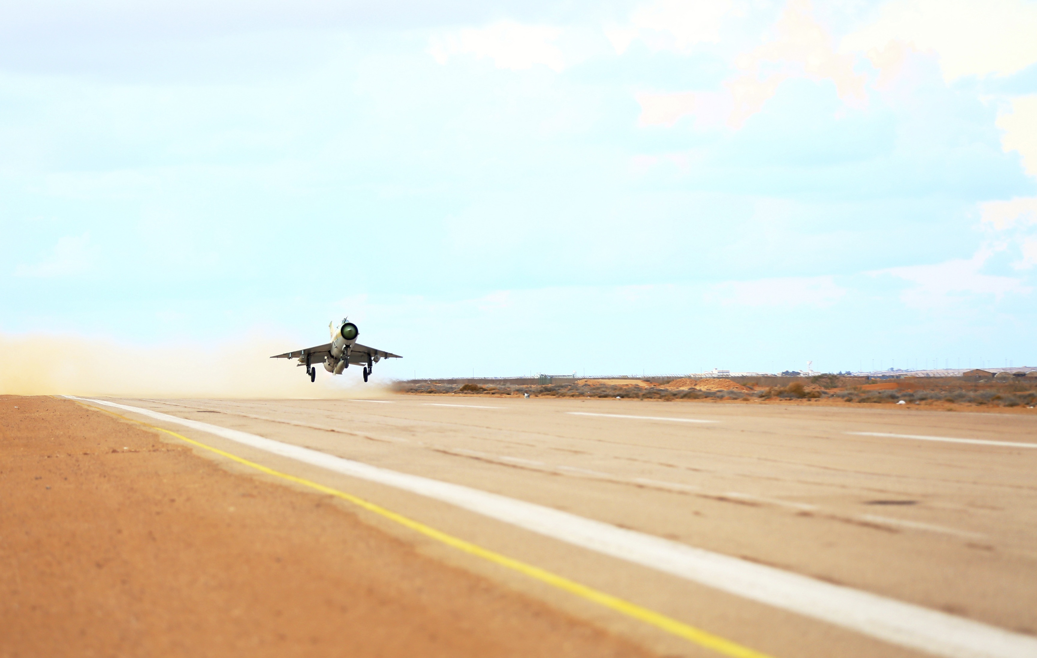 A MiG-21 fighter jet belonging to forces loyal to former general Khalifa Haftar takes off from a base on the outskirts of Al Sidra oil port, in Ras Lanuf December 20, 2014, on its way to hit sites of Libyan Army Forces belonging to Libya's rival government, that are part of the Alshorooq (Libya Dawn). Picture taken December 20, 2014. REUTERS/Stringer (LIBYA - Tags: MILITARY CIVIL UNREST)