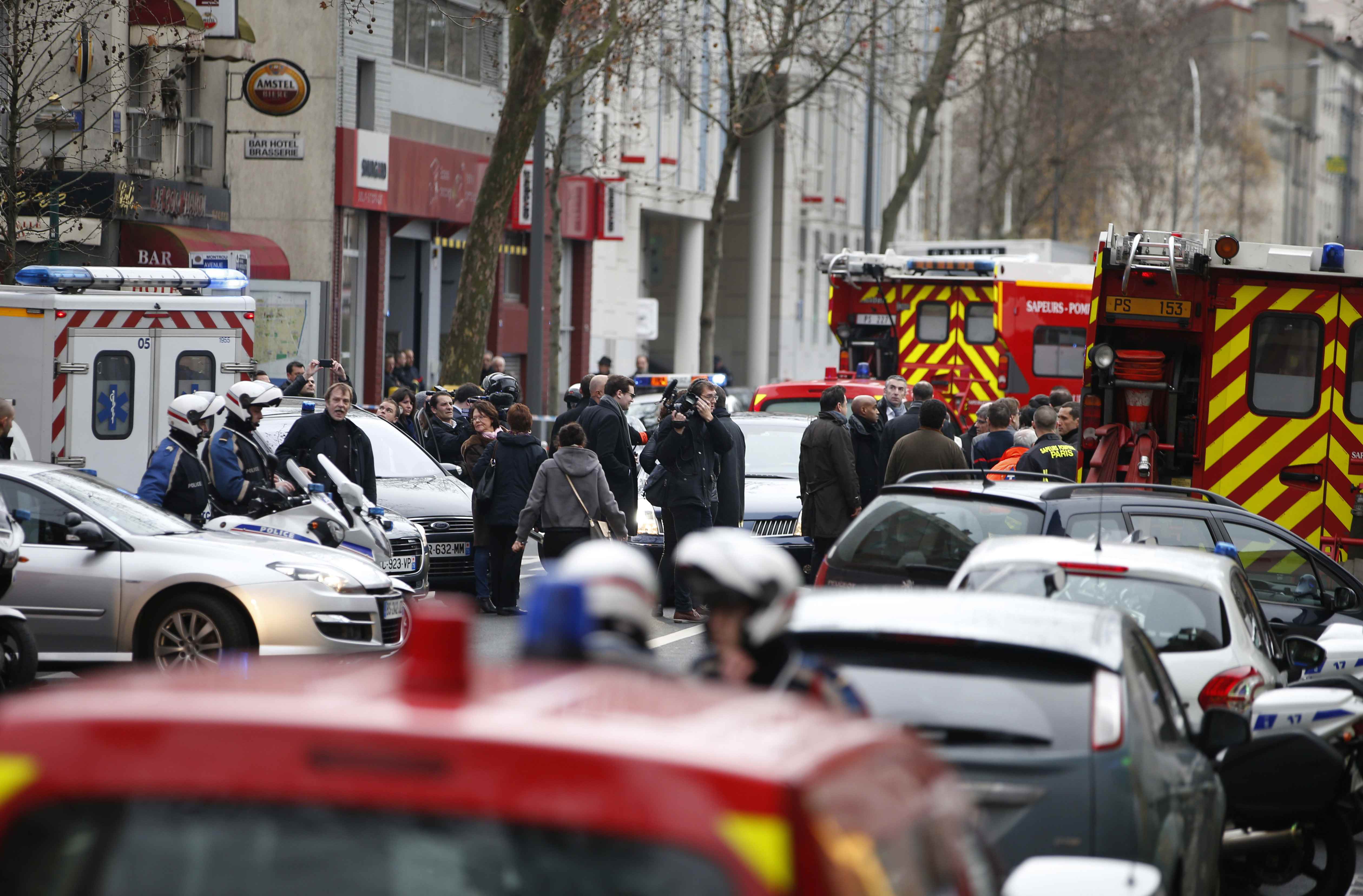 General view of police and rescue crews after a shooting in the street of Montrouge near Paris January 8, 2015. A police officer was wounded in a shootout in southern Paris on Thursday, a police source told Reuters, adding that it was unclear at this stage whether there was any link to the killings at the Charlie Hebdo magazine.Television station iTELE said two police officers were lying on the ground after the attack. REUTERS/Charles Platiau (FRANCE - Tags: CRIME LAW)